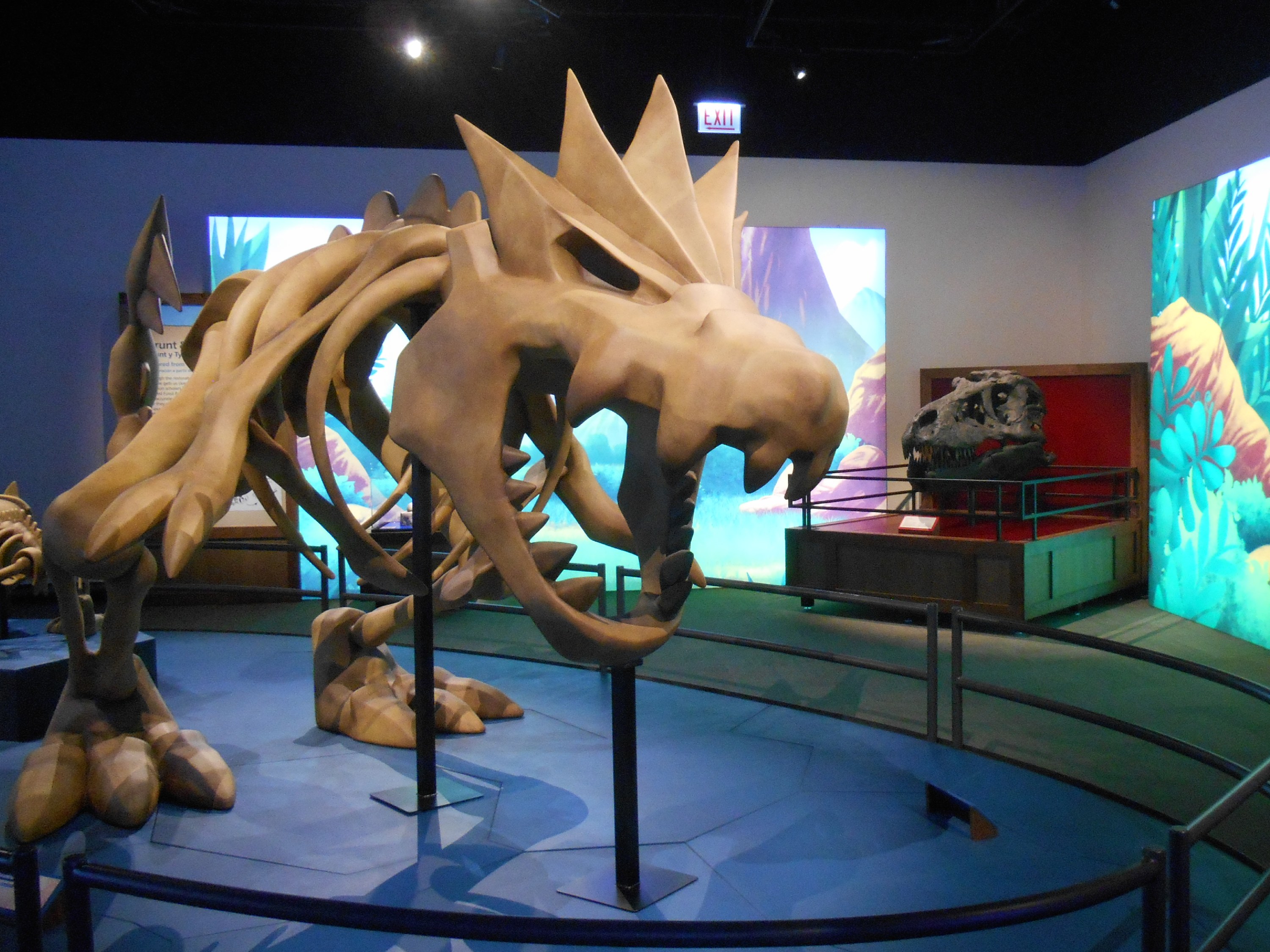A statue of the Pokémon “Tyrantrum” (left) and the Tyrannosaurus Rex skull (right) at the Pokémon Fossil Museum | Taken Sept 30, 2026, by Fabrizio E. Paco
